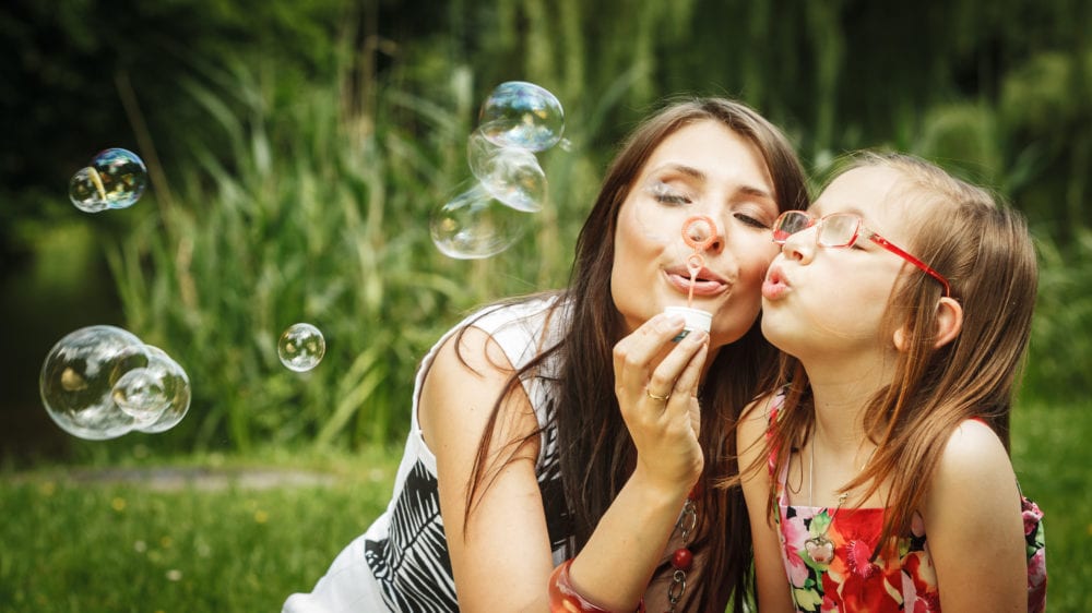 A Young Girl Blowing Bubbles Stock Photo